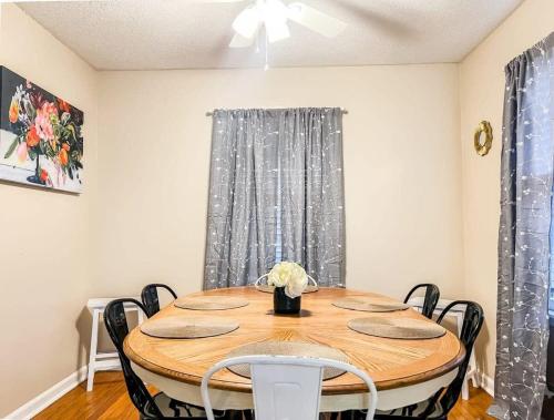 a dining room with a wooden table and chairs at Brick Point Place- 10 Min N of UAH in Huntsville