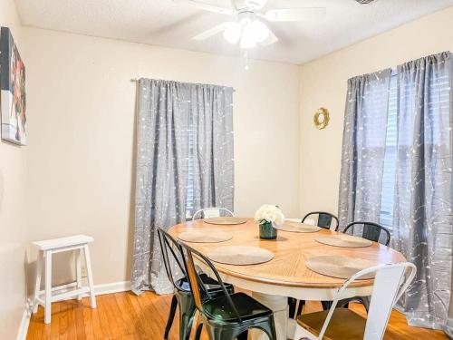 a dining room with a wooden table and chairs at Brick Point Place- 10 Min N of UAH in Huntsville