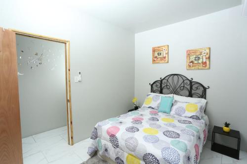 a bedroom with a bed and a mirror at Home Away From Home in Kingston