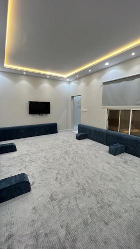 a large room with a couch and a flat screen tv at منتجع لي فارد in Taif