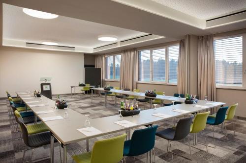 a conference room with a long table and chairs at Holiday Inn - Villingen - Schwenningen by IHG in Villingen-Schwenningen