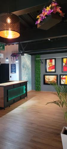 a room with a desk and flowers on the wall at HOTEL MAQUIAVELO SOLO ADULTOS in Puebla