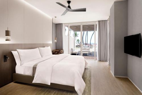 a bedroom with a bed with a ceiling fan at The Westin Resort Guam in Tumon