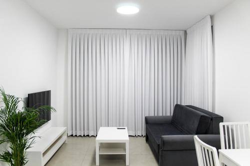 a living room with a couch and a table at Luxury Suite Apartment With Sea View #53 By Hashdera Eilat in Eilat