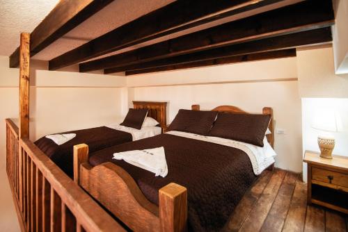 two beds in a room with wooden floors at Hotel Casa Moreno La vega C in La Vega
