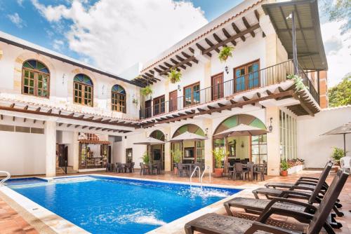 an exterior view of a house with a swimming pool at Hotel Casa Moreno La vega C in La Vega