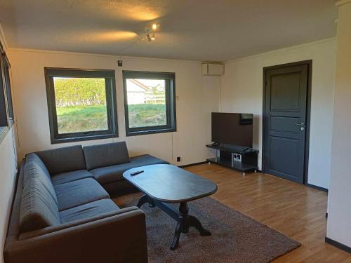 a living room with a couch and a table at Novkrokene - Spacious and fully equipped 3 beds apartment with free parking in Stavanger