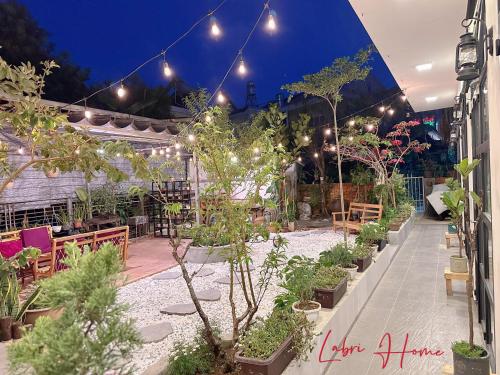 a patio with a bunch of potted plants and lights at Labri Home Da Lat in Da Lat