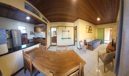 a kitchen and living room with a wooden ceiling at Apartamento Buziano in Búzios