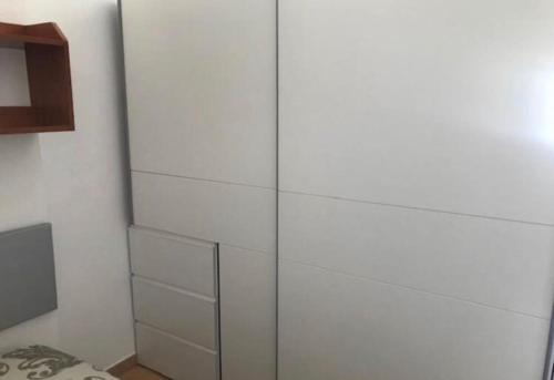 a white cabinet with glass doors in a room at Apartaestudio Villanueva del Trabuco in Villanueva del Trabuco