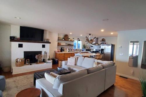 a living room with a couch and a fireplace at The Driftwood - Hot tub with Lake views in Leamington