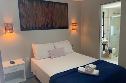 a bedroom with a bed with a towel on it at Hosts BR - Flat Vista Mar no Meireles in Fortaleza