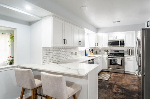 a kitchen with white cabinets and a white counter top at Pet-Friendly Southwest Austin Home with BBQ in Austin