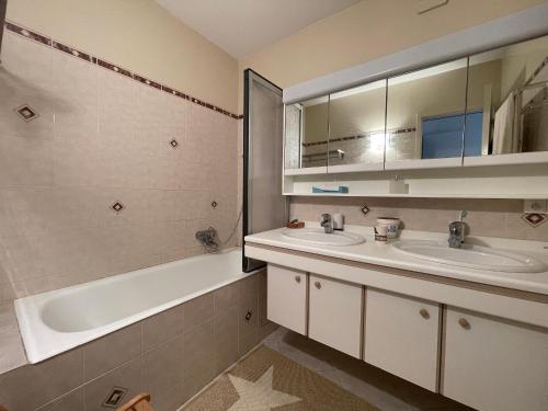 une salle de bain avec deux lavabos et une baignoire dans l'établissement Duplex T5 avec Terrasse Panoramique à 150m de la Plage - Arcachon - FR-1-420-130, à Arcachon