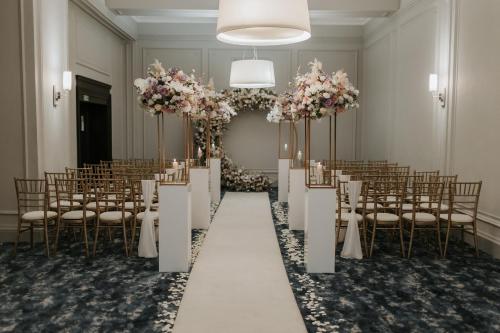 a banquet hall with chairs and tables and flowers at voco Grand Central Glasgow by IHG in Glasgow