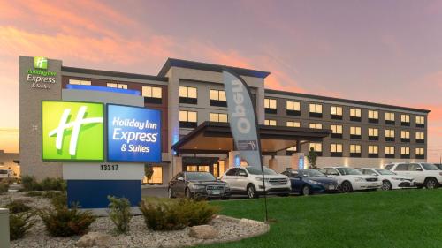 a building with cars parked in a parking lot at Holiday Inn Express & Suites Racine by IHG in Racine