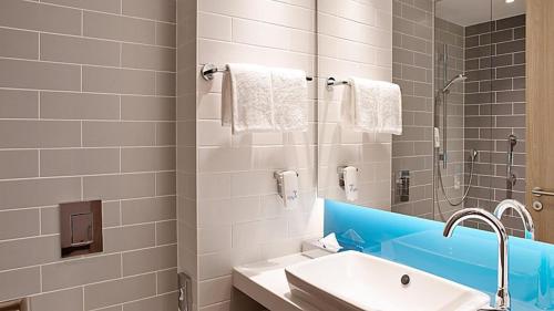 a bathroom with a sink and a shower at Holiday Inn Express - Remscheid in Remscheid