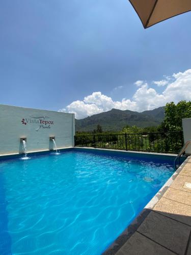 a swimming pool with a view of the mountains at Posada Vista Tepoz in Tepoztlán