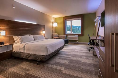 a hotel room with a bed and a television at Holiday Inn Express & Suites Victoria-Colwood by IHG in Victoria