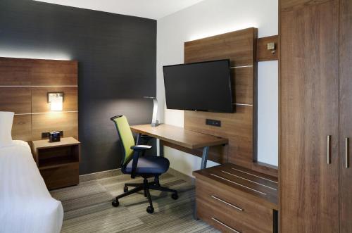 a hotel room with a desk and a television at Holiday Inn Express Toronto Downtown by IHG in Toronto