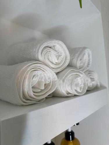 a pile of white towels sitting on a shelf at Birmingham City Centre Rotunda. in Birmingham