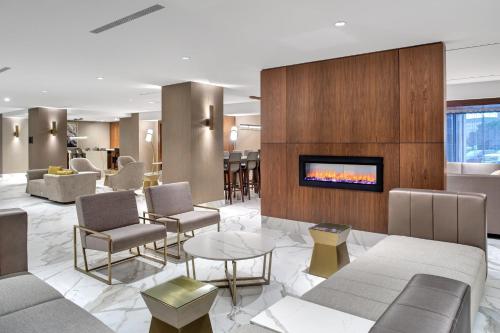 a lobby with couches and chairs and a fireplace at Crowne Plaza Toronto Airport, an IHG Hotel in Toronto