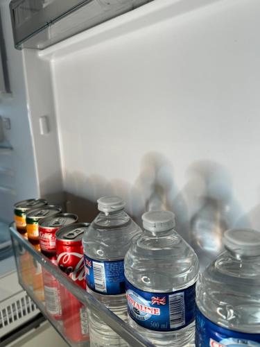 a group of water bottles in an open refrigerator at Birmingham City Centre High Rise Apartment Rotunda in Birmingham