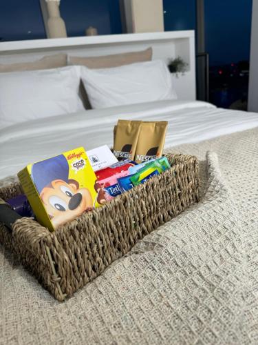 a basket on a bed with books and other items at Birmingham City Centre Rotunda. in Birmingham