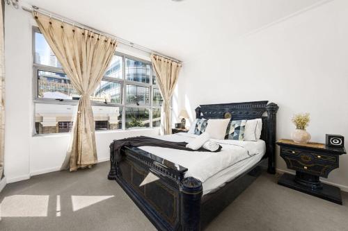 a bedroom with a large bed and a window at A Cozy Apt for 6 Right Next to Darling Harbour in Sydney