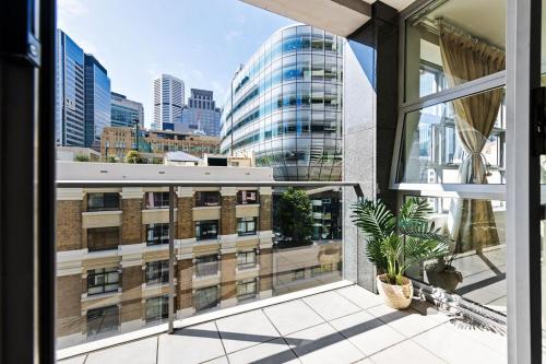 an apartment balcony with a view of a building at A Cozy Apt for 6 Right Next to Darling Harbour in Sydney
