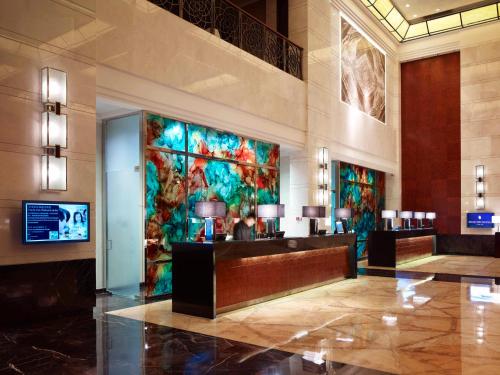 a lobby of a hotel with a large painting on the wall at InterContinental Foshan, an IHG Hotel - Free Shuttle Bus for Canton Fair in Foshan
