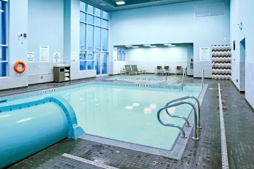 a large swimming pool in a building at Holiday Inn Hotel & Suites - Calgary Airport North by IHG in Calgary