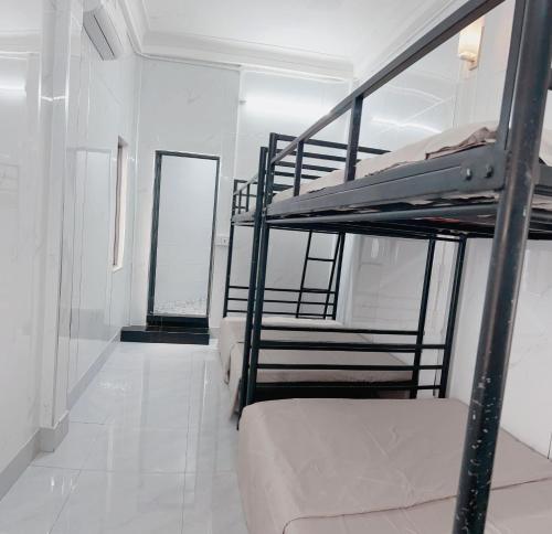 a room with two bunk beds and a hallway at KING HOMESTAY in Hue
