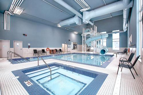 a large swimming pool in a building at Holiday Inn Express & Suites - Calgary Airport Trail NE by IHG in Calgary
