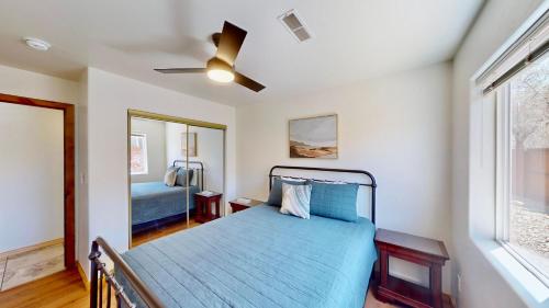 a bedroom with a blue bed and a window at Canyon Portal #469 in Moab