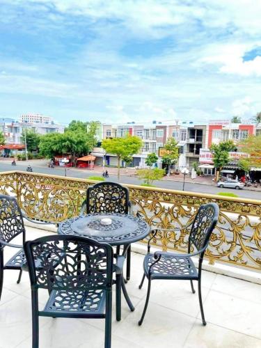 a table and chairs on a balcony with a view of a city at Khách Sạn Tường Vy in An HÃ²a