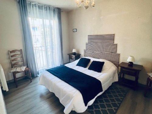 une chambre avec un grand lit et une grande fenêtre dans l'établissement F2 avec balcon, parking et équipements complets à Amélie-les-Bains-Palalda - FR-1-703-176, à Amélie-les-Bains-Palalda