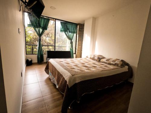 ボゴタにあるHospedaje Campin 60 60のベッドルーム1室(ベッド1台、大きな窓付)