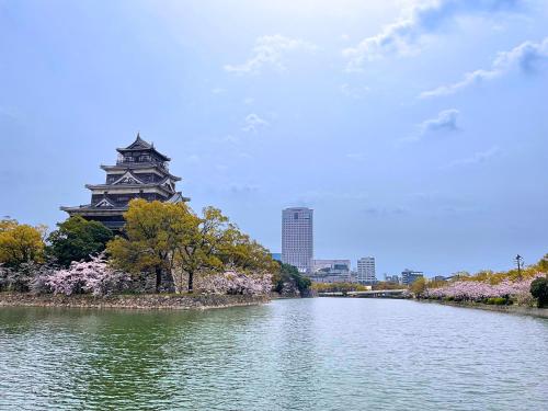 a view of a river with a building in the background at Rihga Royal Hotel Hiroshima in Hiroshima