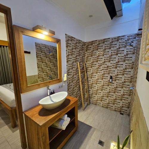 a bathroom with a sink and a mirror at Villa Casablanca Surf Keramas in Keramas