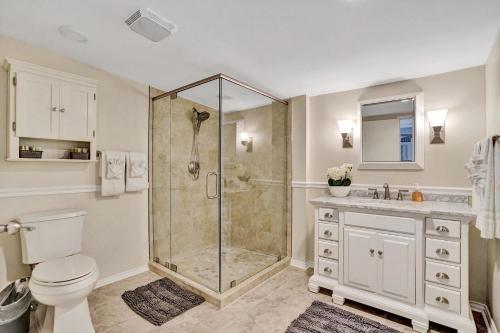 a bathroom with a shower with a toilet and a sink at Modern 5BR with Heated Pool 5 min to Beach in Pompano Beach