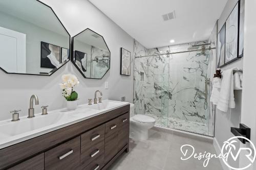 a bathroom with a sink and a shower at Charming 9BR New-Build Home w Heated Pool & Games in Hollywood