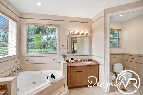 a bathroom with a tub and a sink at Gorgeous venetian home walk to beach with HOTTUB in Hollywood