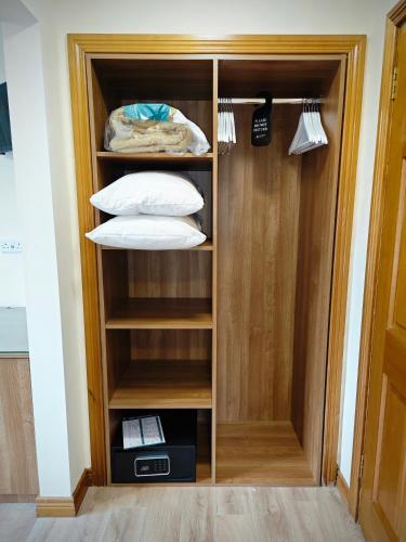 a wooden closet with pillows and acomputer in it at Mountain View Accommodation in Donegal