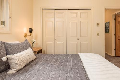 a bedroom with a large white closet and a bed at Mountain Creek Chalet in Girdwood