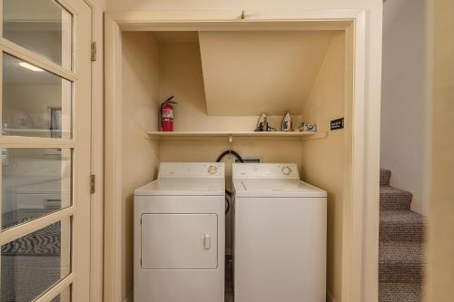 a small laundry room with two washer and dryer at Mountain Creek Chalet in Girdwood