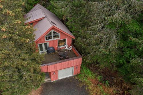 an aerial view of a red house in the woods at Mountain Creek Chalet in Girdwood