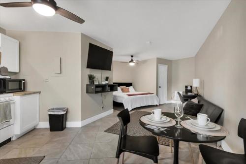 a living room with a bed and a table and chairs at King Bed Modern Studio Apartment in Huntsville