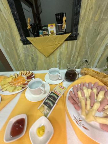 a table topped with plates of food on a table at HOSTAL LAS GARZAS in Talara