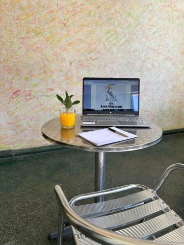 a laptop computer sitting on a table with a chair at HOSTAL LAS GARZAS in Talara